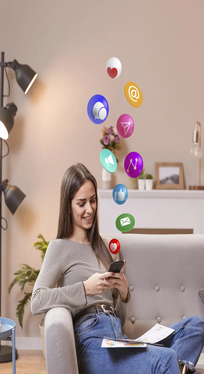 a woman is sitting holding phone in her hand and many apps are highlighted above her head 